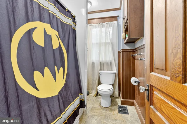 a bathroom with a toilet and a shower