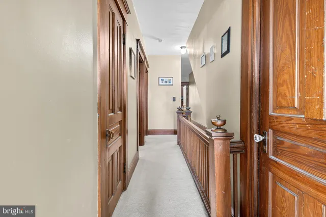 a bedroom with a bed and large windows