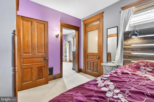 a bedroom with a bed and a mirror