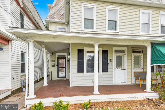 a view of a brick house with large windows