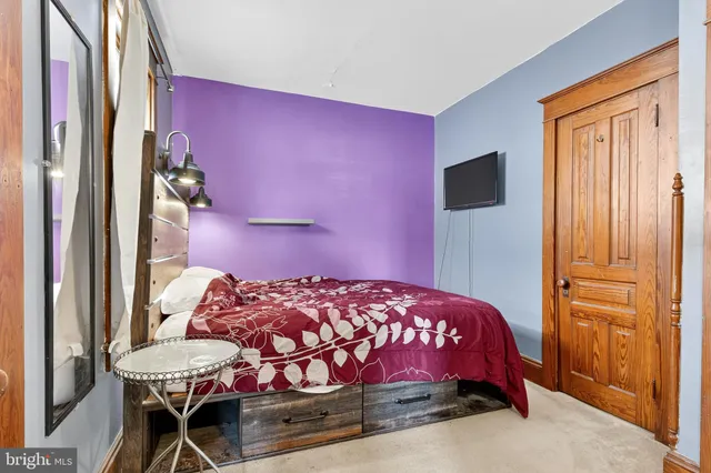 a spacious bedroom with a bed and a window