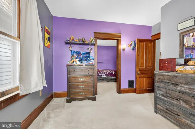 a view of a hallway with wooden floor and entryway