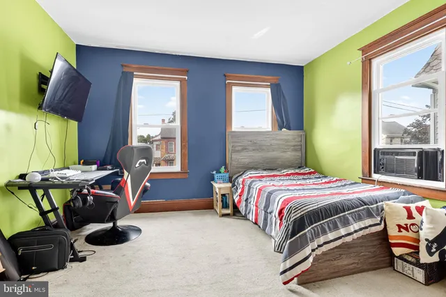 a bedroom with a bed and a mirror