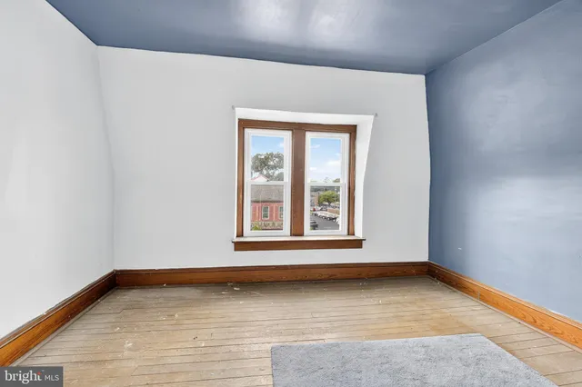 a view of a backyard with table and chairs and a large tree