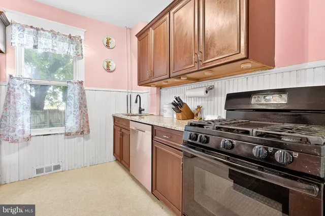 a kitchen with stainless steel appliances granite countertop a stove and a microwave