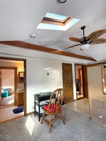 a view of a livingroom with furniture and a ceiling fan