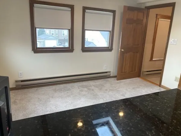 a view of room with window and hallway