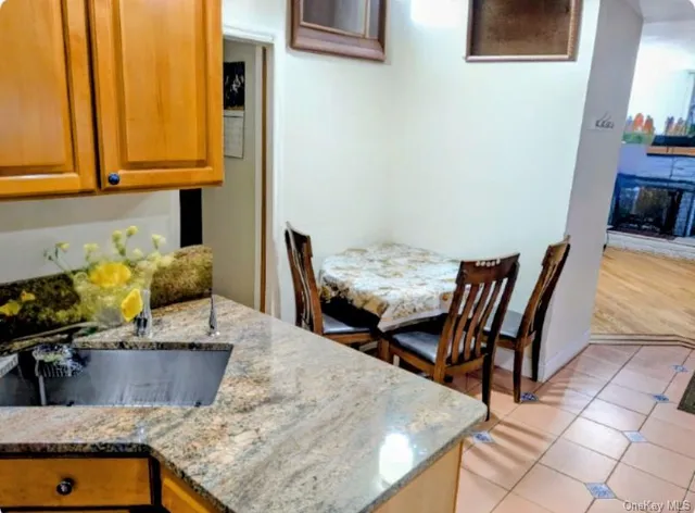 a kitchen with stainless steel appliances granite countertop a sink a microwave cabinets and a dining table