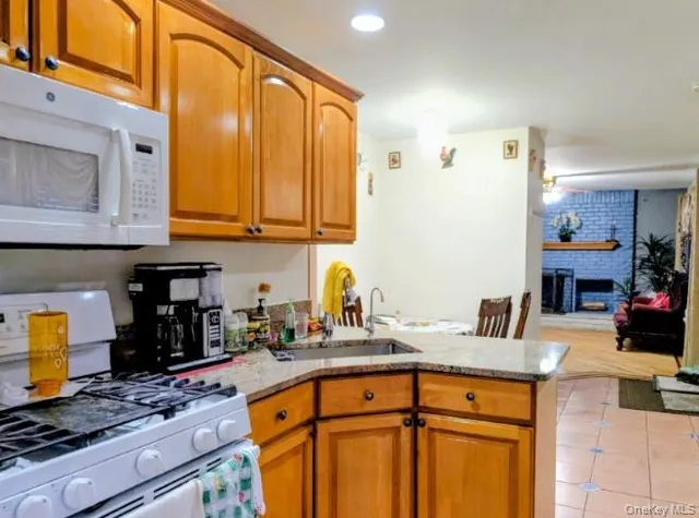 a kitchen with stainless steel appliances granite countertop a sink stove and cabinets