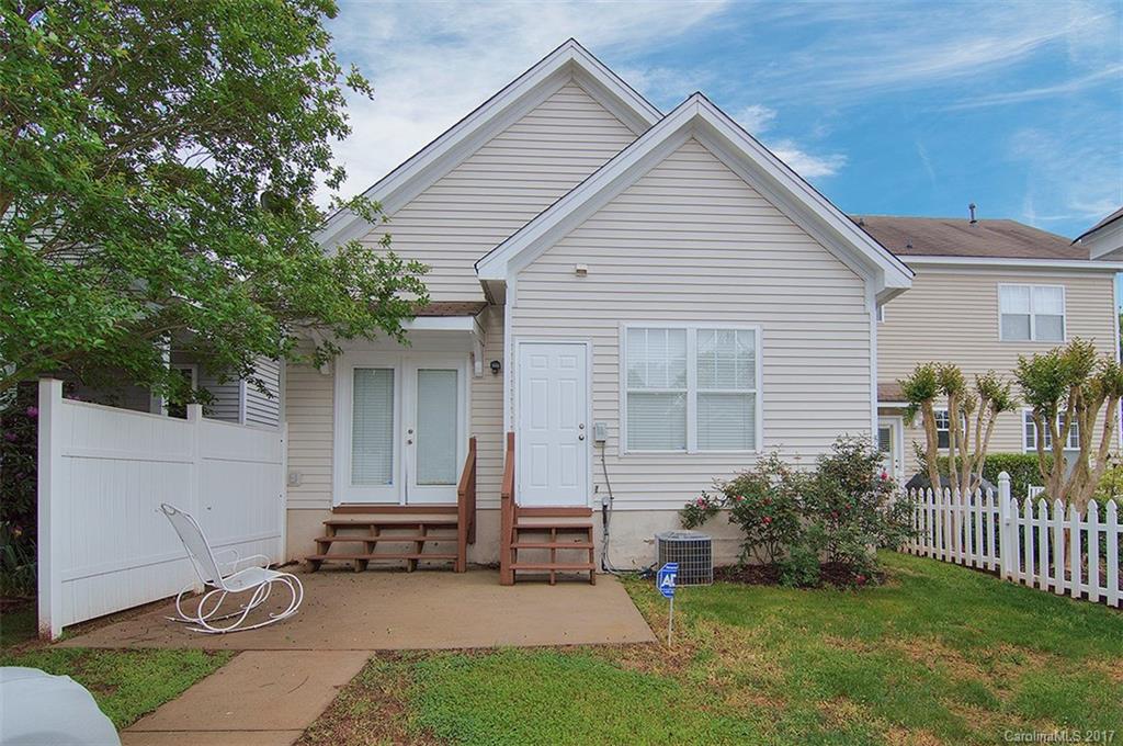 11326 Deer Ridge Lane Charlotte, NC 28277 - Photo 2 of 21 a view of a house with a yard and table and chair under an umbrella