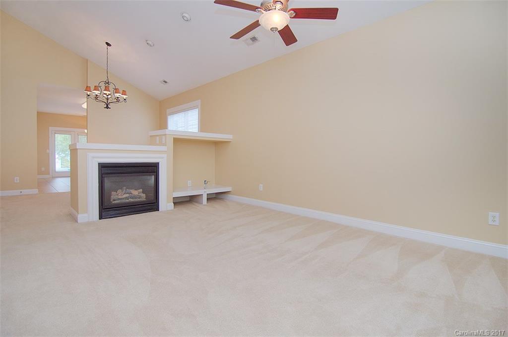 11326 Deer Ridge Lane Charlotte, NC 28277 - Photo 13 of 21 an empty room with a fireplace and fan