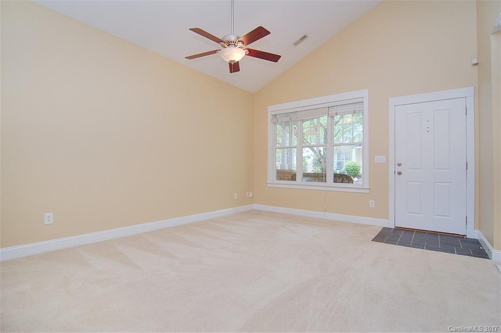 11326 Deer Ridge Lane Charlotte, NC 28277 - Photo 15 of 21 an empty room with chandelier fan and windows