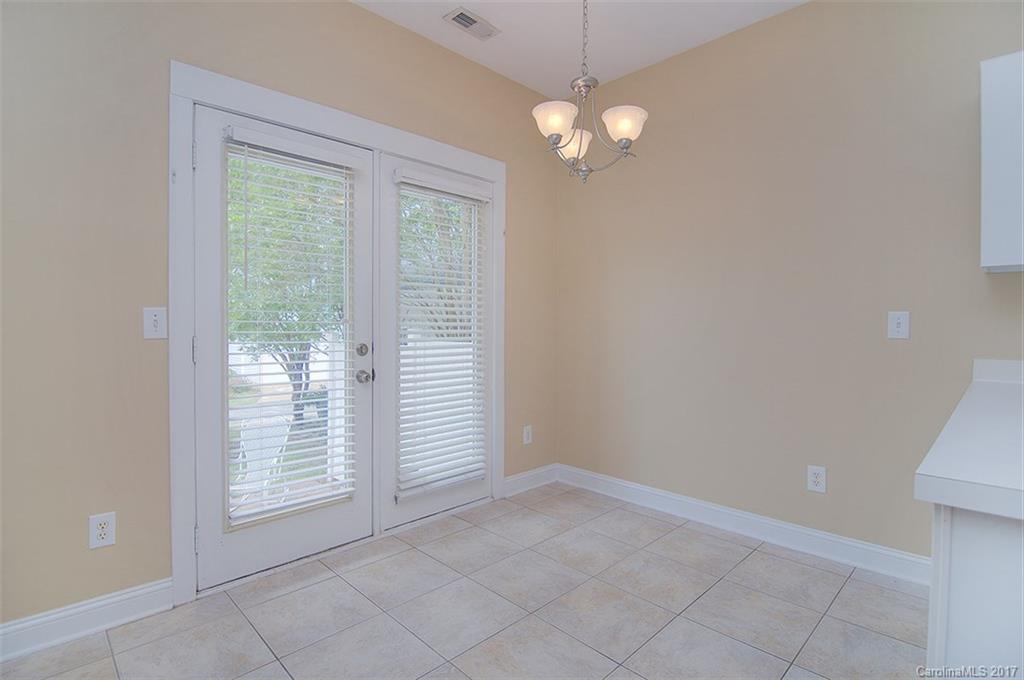 11326 Deer Ridge Lane Charlotte, NC 28277 - Photo 5 of 21 en empty room with windows and chandelier fan