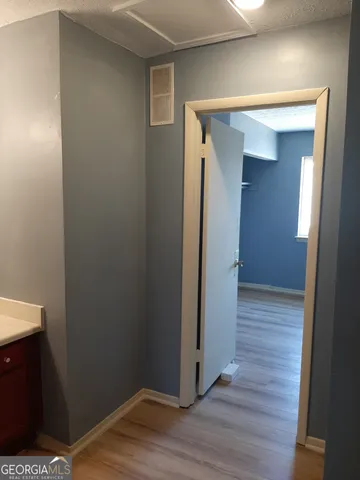 a view of a hallway with wooden floor