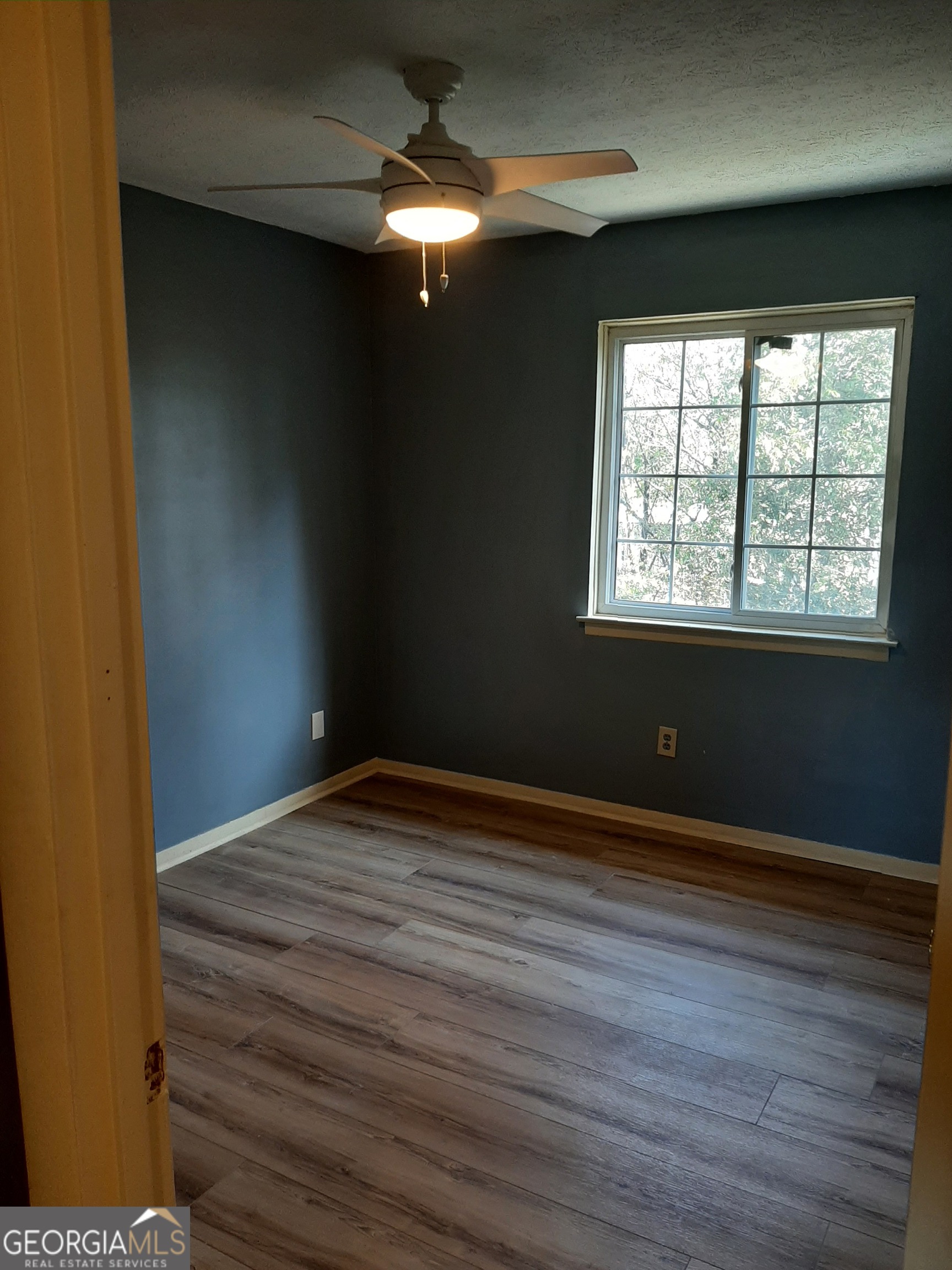 1625 Conley Road, Unit 171 Conley, GA 30288 - Photo 18 of 27 a view of an empty room with wooden floor and a window