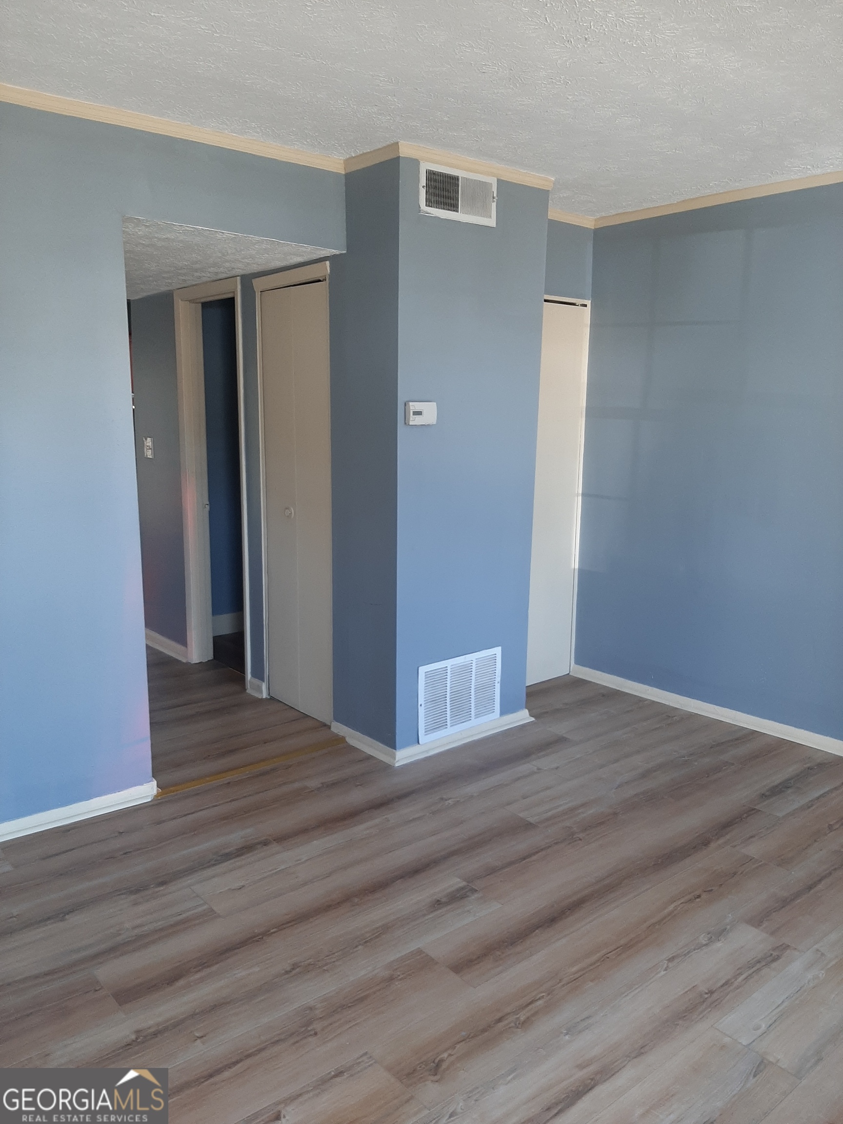 1625 Conley Road, Unit 171 Conley, GA 30288 - Photo 2 of 27 a view of an empty room with wooden floor & closet