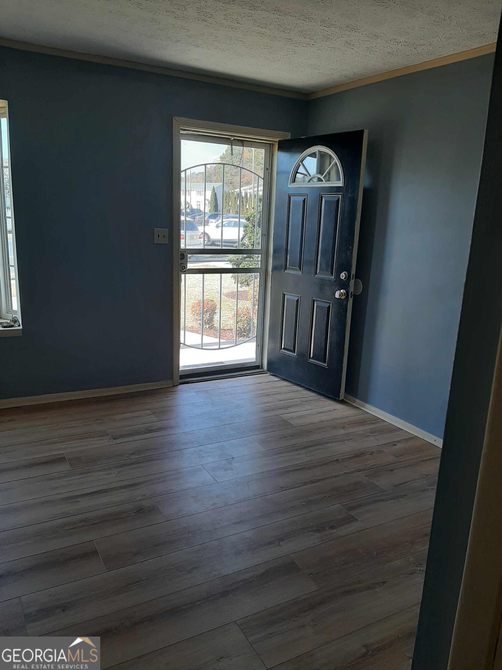 1625 Conley Road, Unit 171 Conley, GA 30288 - Photo 4 of 27 a view of an empty room with wooden floor and a window