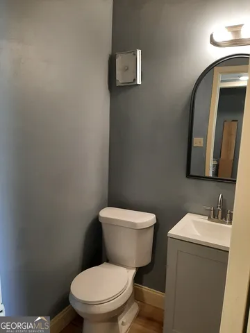 a white toilet sitting next to a bathroom sink