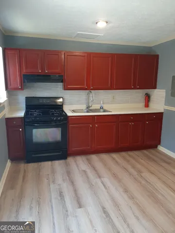 a kitchen with wooden cabinets and a sink