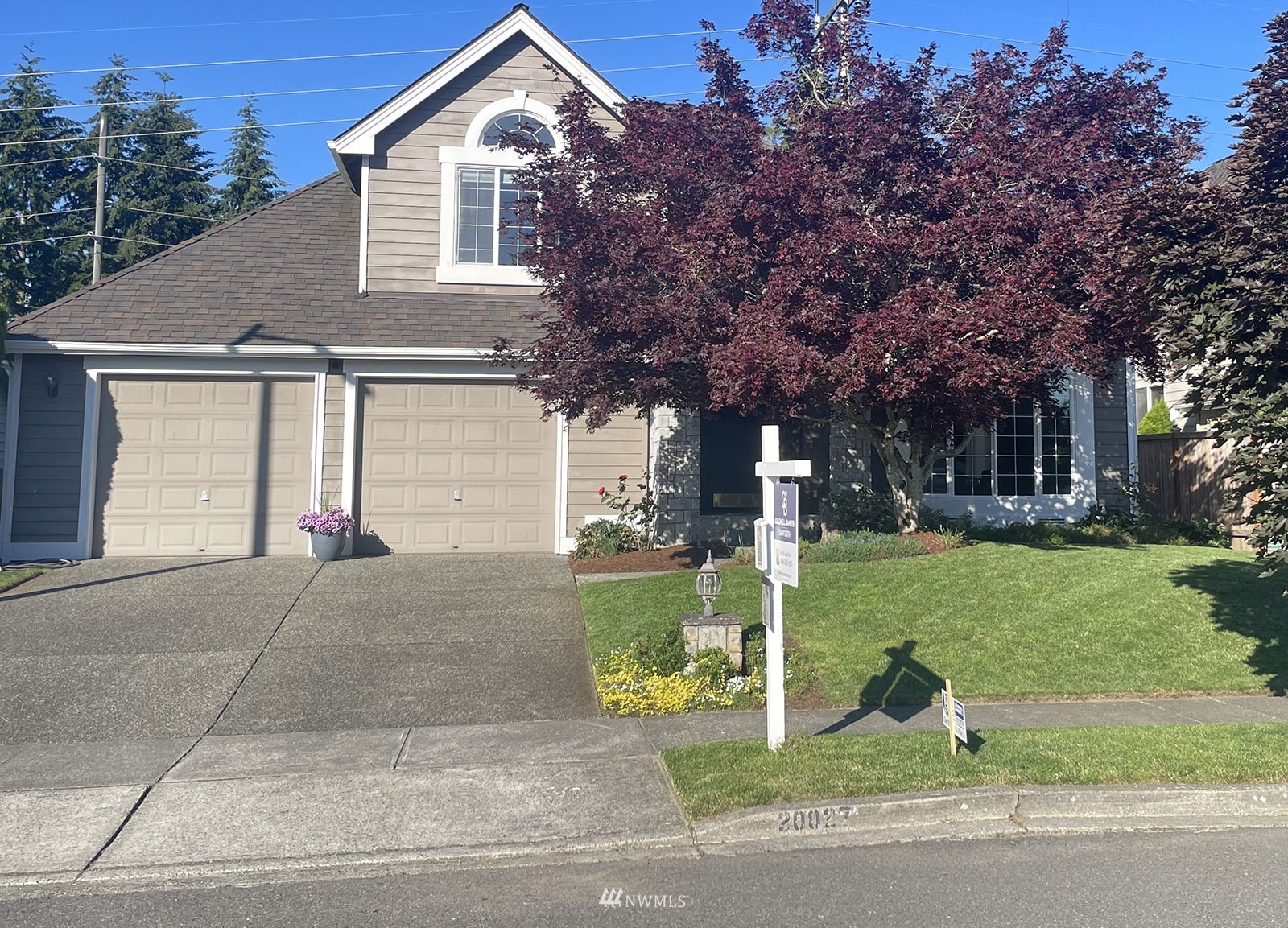 20027 29th Avenue Southeast Bothell, WA 98012 - Photo 1 of 38 a front view of a house with a yard and garage