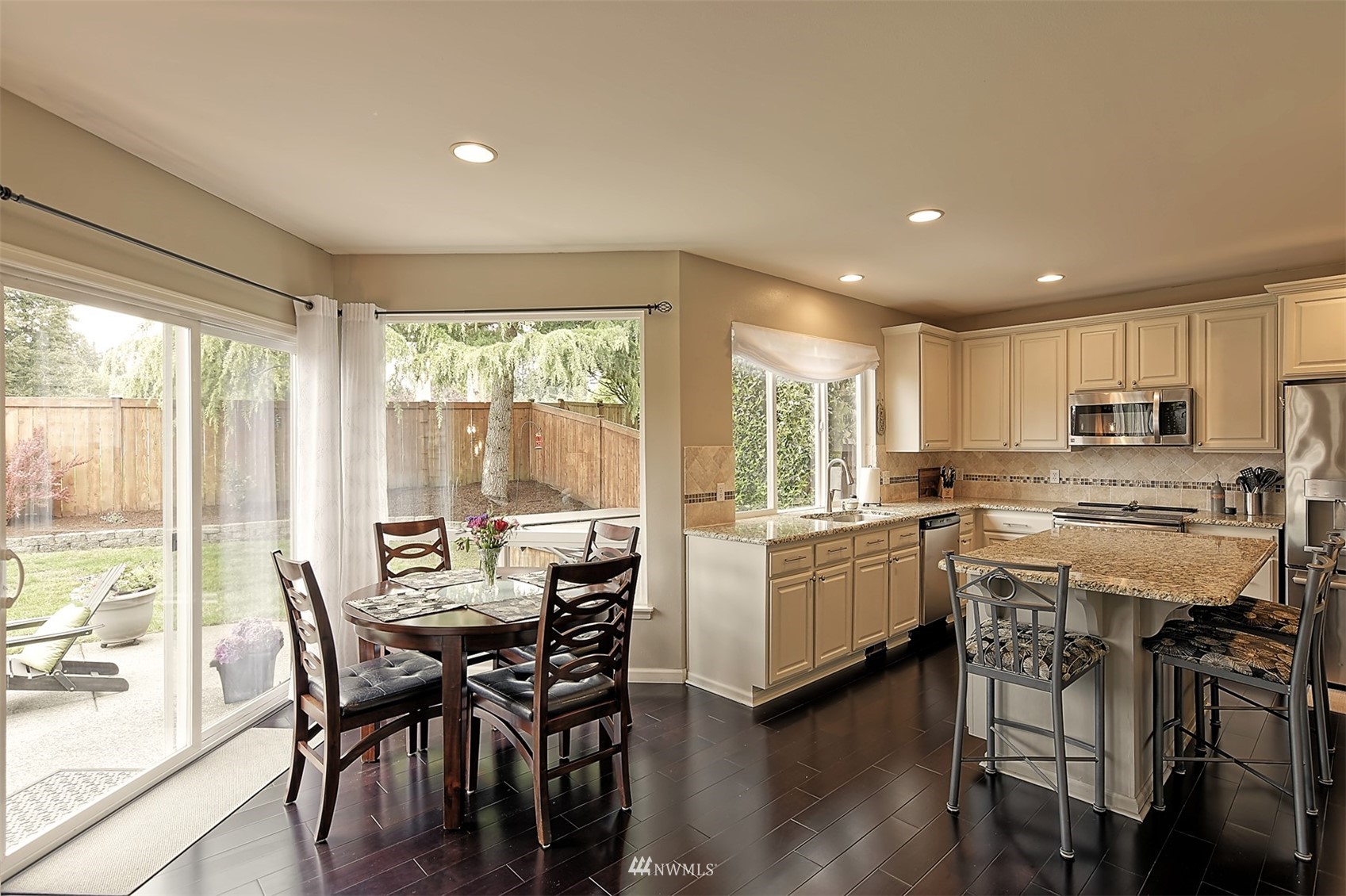 20027 29th Avenue Southeast Bothell, WA 98012 - Photo 13 of 38 a kitchen with a table chairs stove and cabinets