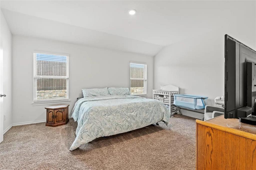 171 Seabiscuit Road Caddo Mills, TX 75135 - Photo 7 of 19 a bedroom with a bed and a flat tv screen on dresser