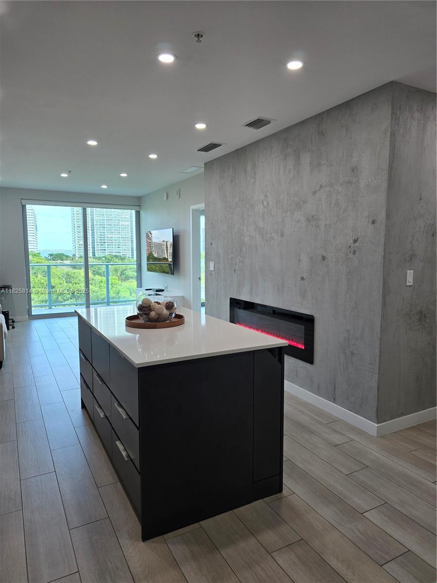 a kitchen with kitchen island a sink stainless steel appliances and cabinets