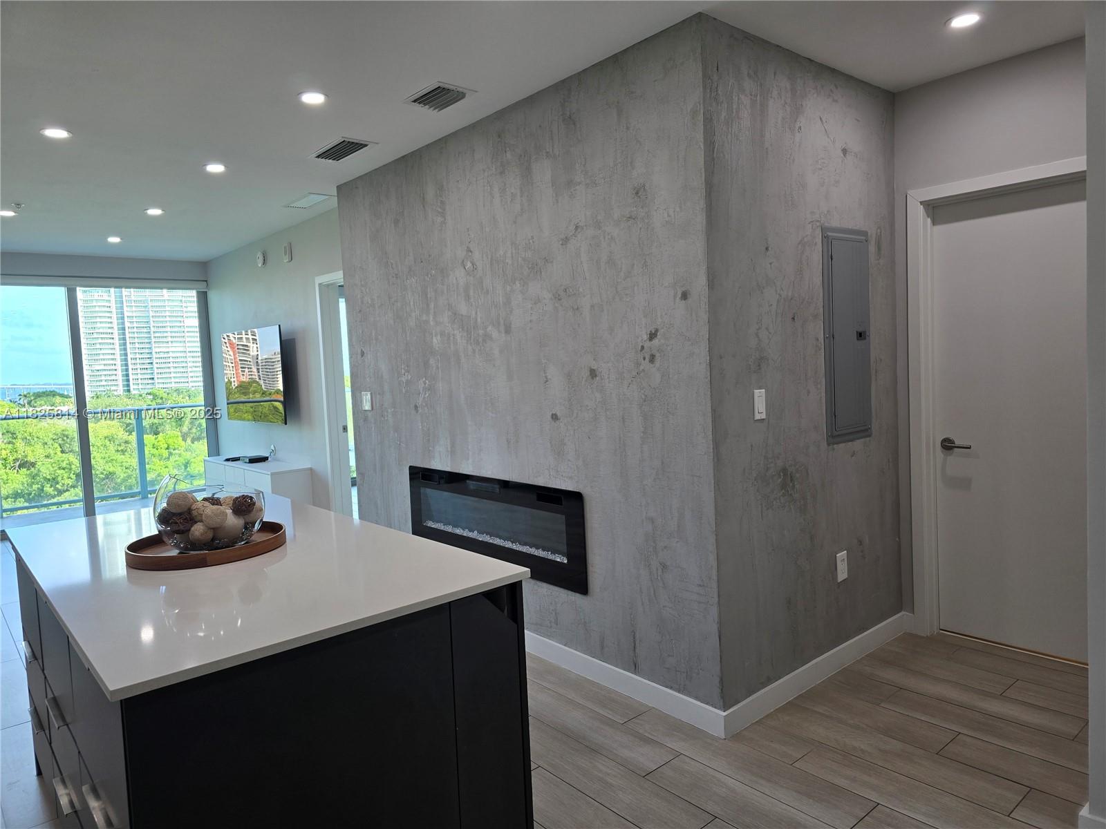 1600 Southwest 1st Avenue, Unit 809 Miami, FL 33129 - Photo 2 of 24 a kitchen with a sink and wooden floor