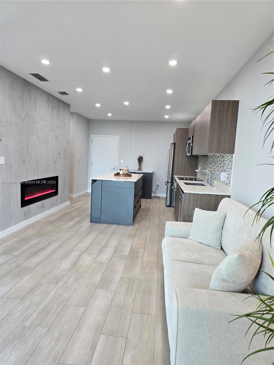 1600 Southwest 1st Avenue, Unit 809 Miami, FL 33129 - Photo 3 of 24 a living room with furniture and a wooden floor