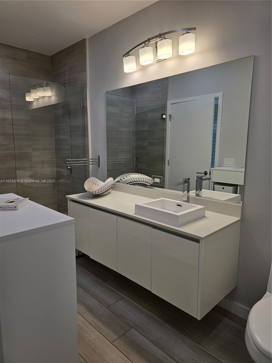 1600 Southwest 1st Avenue, Unit 809 Miami, FL 33129 - Photo 9 of 24 a bathroom with a sink and a mirror