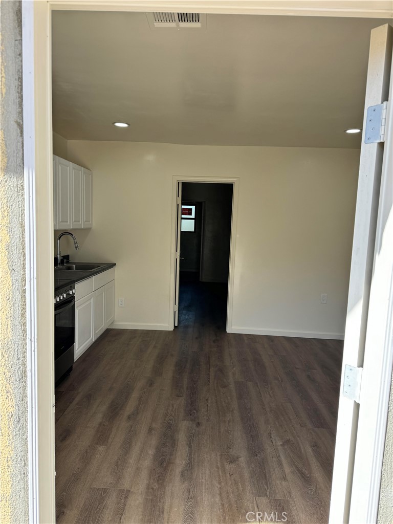 4764 Indian Hill Road Riverside, CA 92501 - Photo 3 of 8 a view of a kitchen with wooden floor and electronic appliances