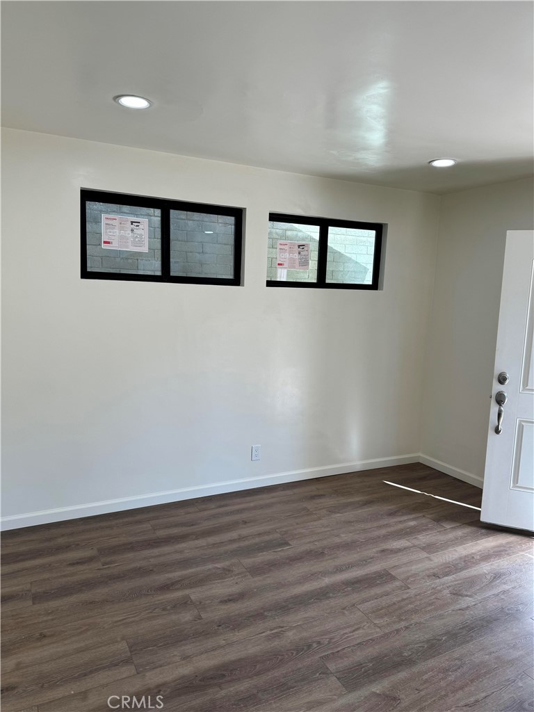 4764 Indian Hill Road Riverside, CA 92501 - Photo 8 of 8 a view of an empty room with wooden floor and a painting