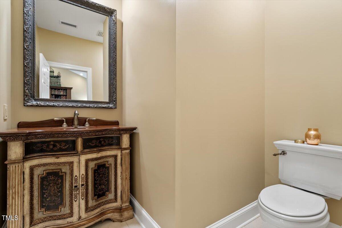 919 Woodham Pittsboro, NC 27312 - Photo 24 of 43 a bathroom with a stove a sink and a mirror