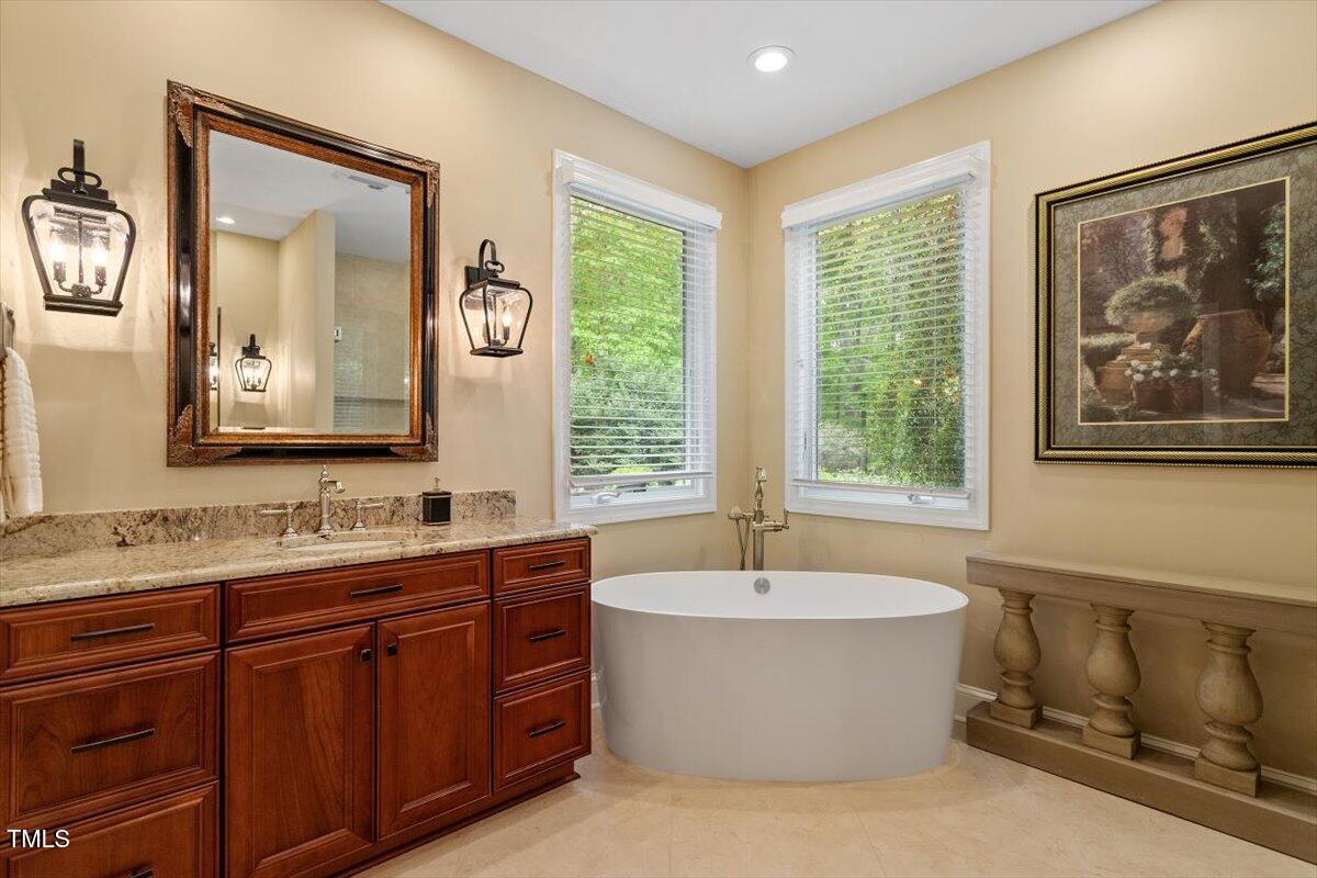919 Woodham Pittsboro, NC 27312 - Photo 27 of 43 a bathroom with a tub a sink and mirror