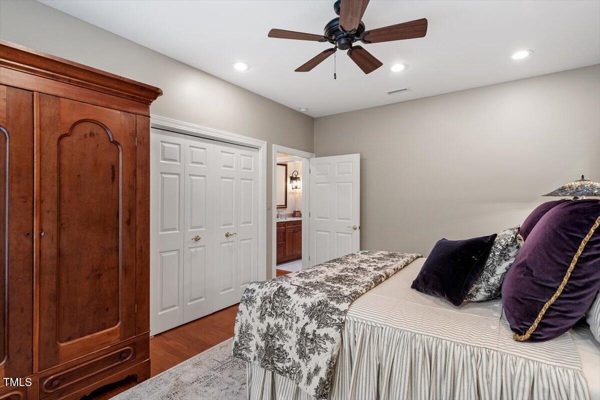 919 Woodham Pittsboro, NC 27312 - Photo 30 of 43 a bedroom with a bed and a chandelier
