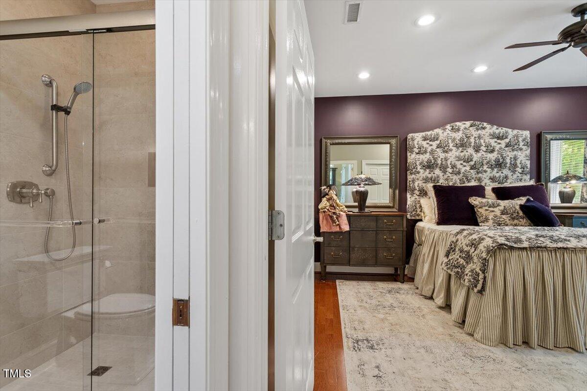 919 Woodham Pittsboro, NC 27312 - Photo 31 of 43 a bed room with a bed and a large mirror