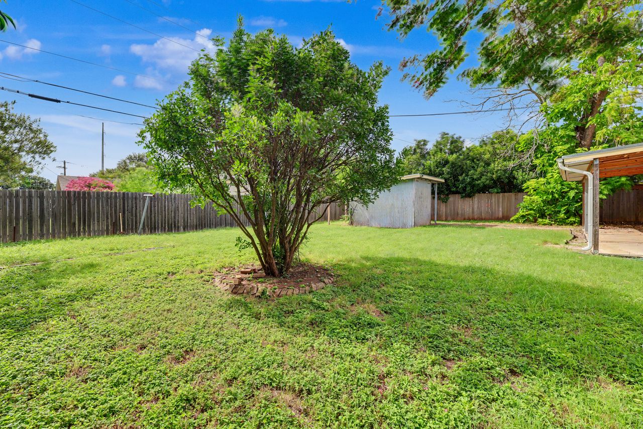 1811 Terry Lane Georgetown, TX 78628 - Photo 40 of 40 A generous grassy lawn unfolds in this private yard, complete with mature landscaping and a useful shed.