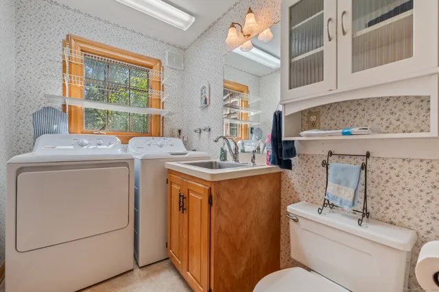 a bathroom with a toilet a sink and a mirror