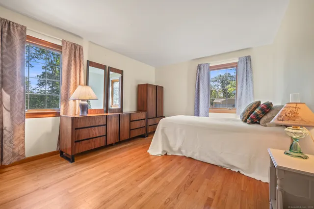 a view of room with window and wooden floor
