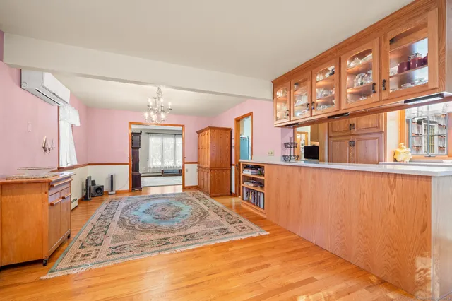 a view of a kitchen with stainless steel appliances granite countertop a refrigerator and a stove top oven