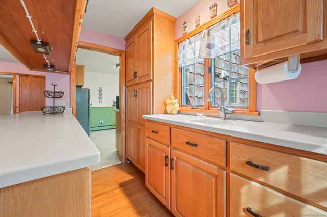 a view of a bath room with a sink and cabinets