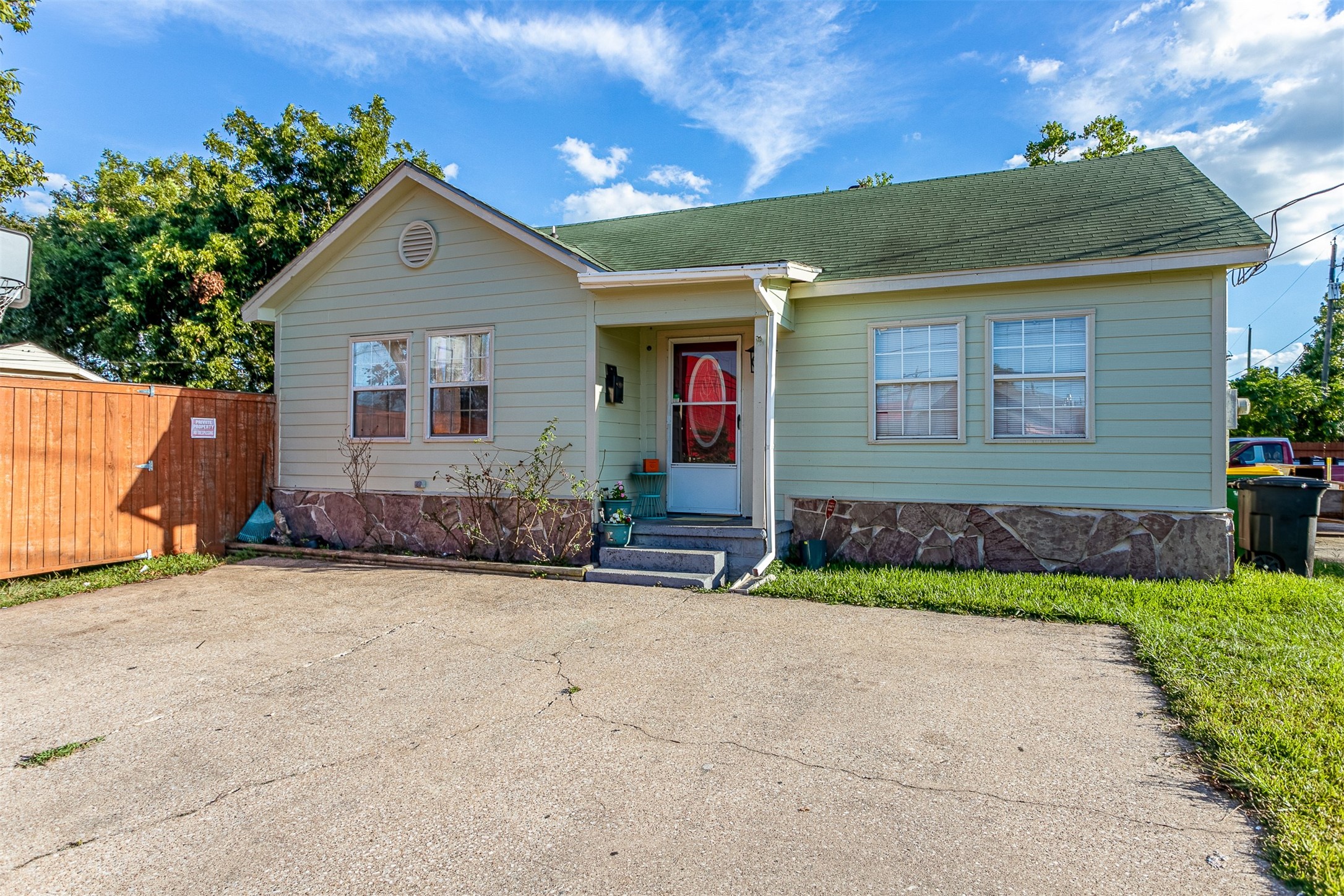a front view of a house with a yard and potted plants