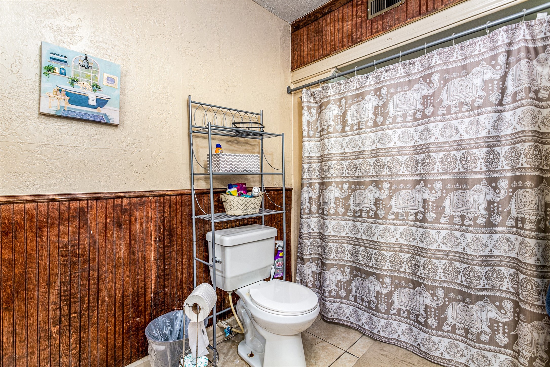 701 Ward Road Baytown, TX 77520 - Photo 11 of 19 a bathroom with a toilet and a shower curtain