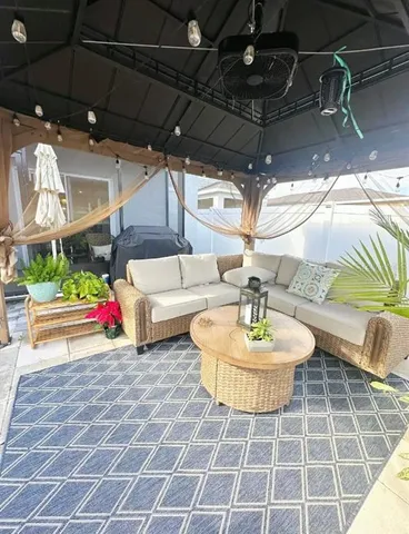 a view of a patio with a table and chairs