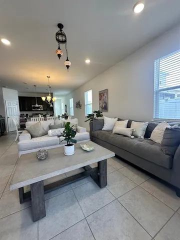 a living room with furniture a rug and white walls