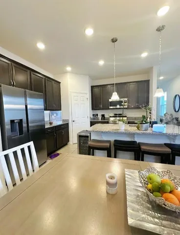 a kitchen with stainless steel appliances kitchen island granite countertop a sink and cabinets