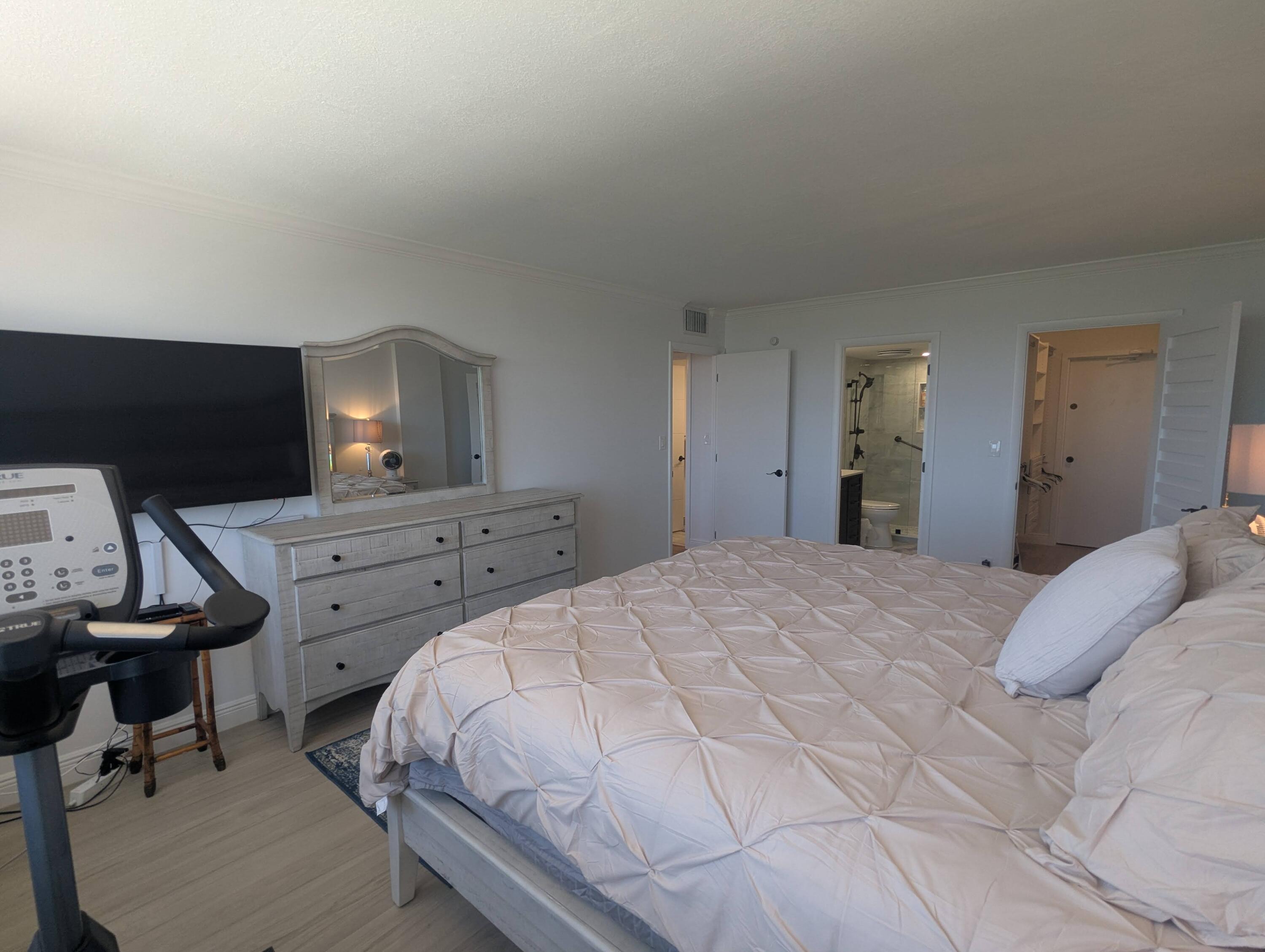 2121 North Ocean Boulevard, Unit 1006E Boca Raton, FL 33431 - Photo 45 of 64 a bedroom with a bed and a flat screen tv