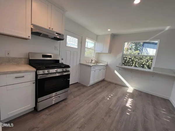 a kitchen with cabinets and stainless steel appliances