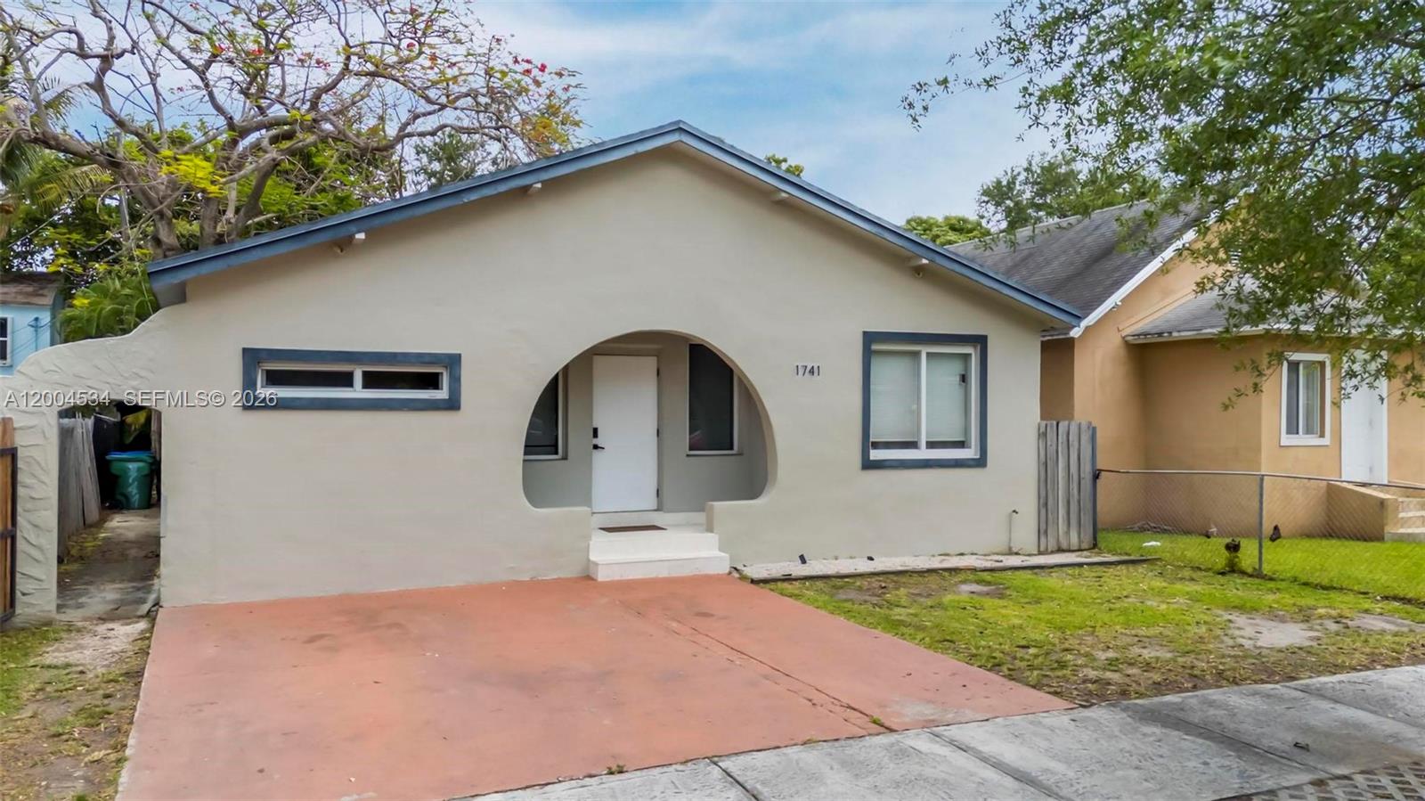 1741 Northwest 44th Street Miami, FL 33142 - Photo 1 of 45 a front view of a house with garden