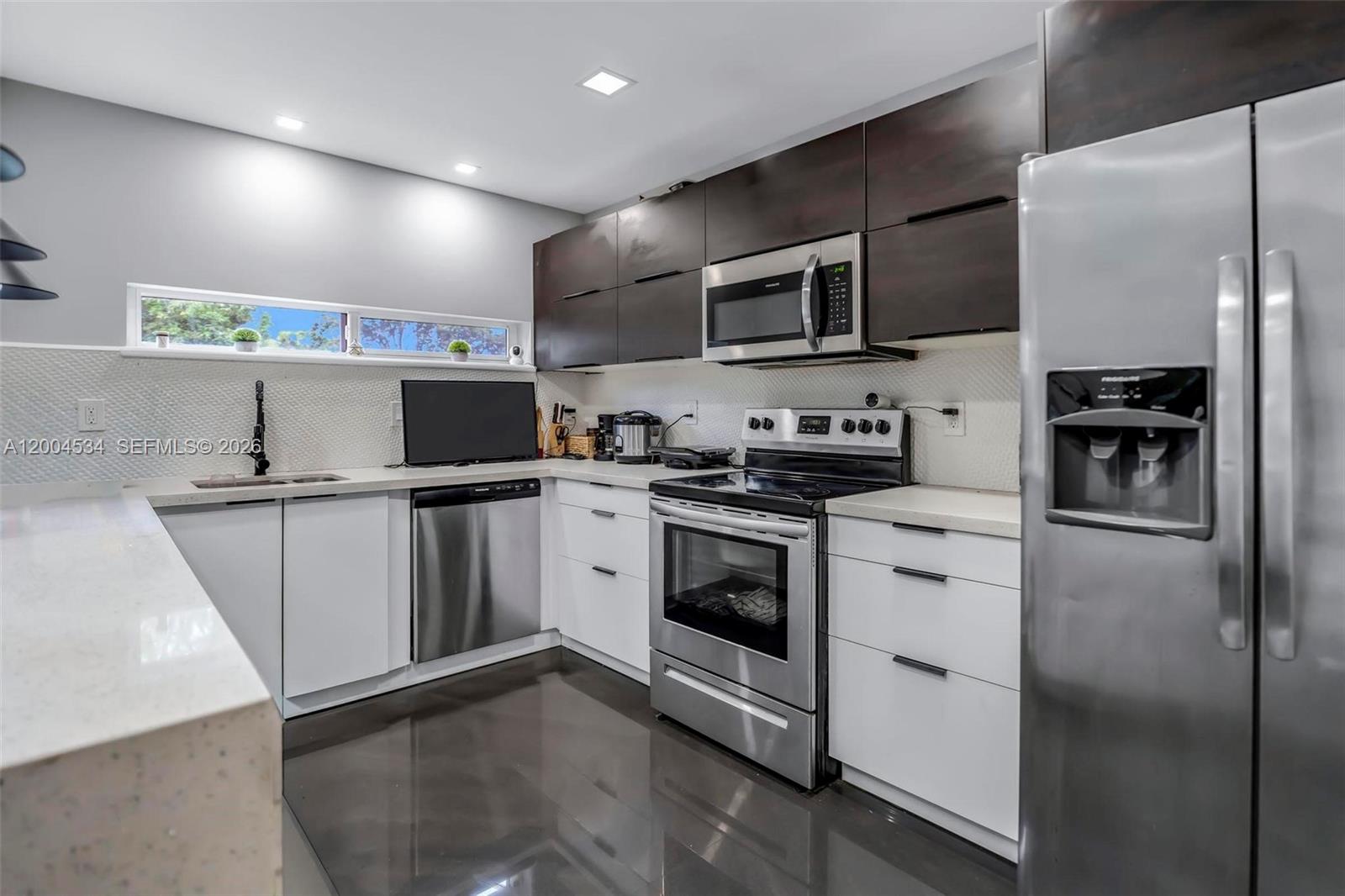 1741 Northwest 44th Street Miami, FL 33142 - Photo 14 of 45 a kitchen with stainless steel appliances granite countertop a refrigerator sink and microwave